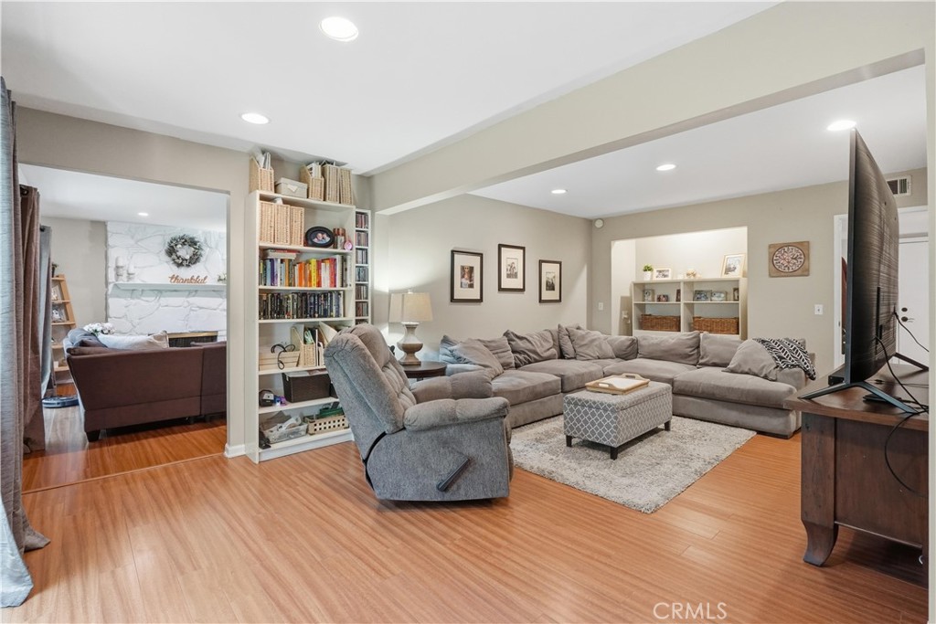 10808 Des Moines Avenue Porter Ranch, CA 91326 - Photo 10 of 39 a living room with furniture and a flat screen tv