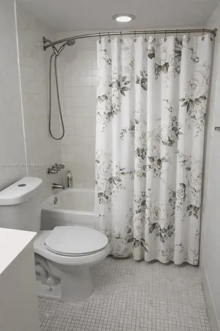 a bathroom with a toilet and shower