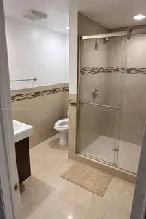 a bathroom with a shower and a toilet