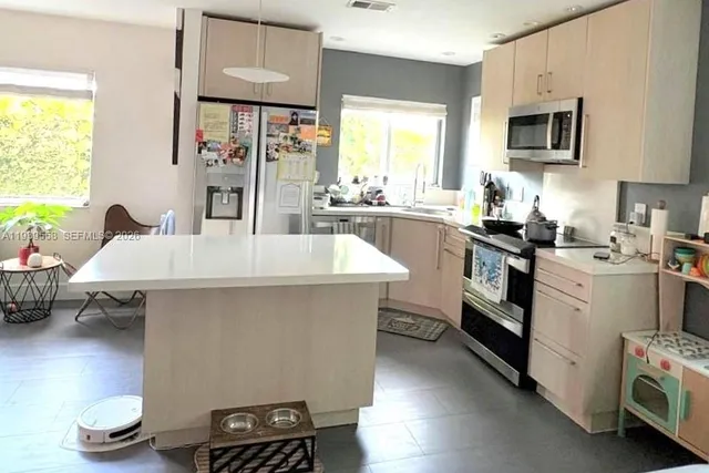 a kitchen with a sink appliances and cabinets