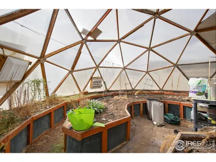a view of a room with wooden floor and iron stairs