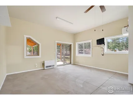 a view of a livingroom with workspace and a window