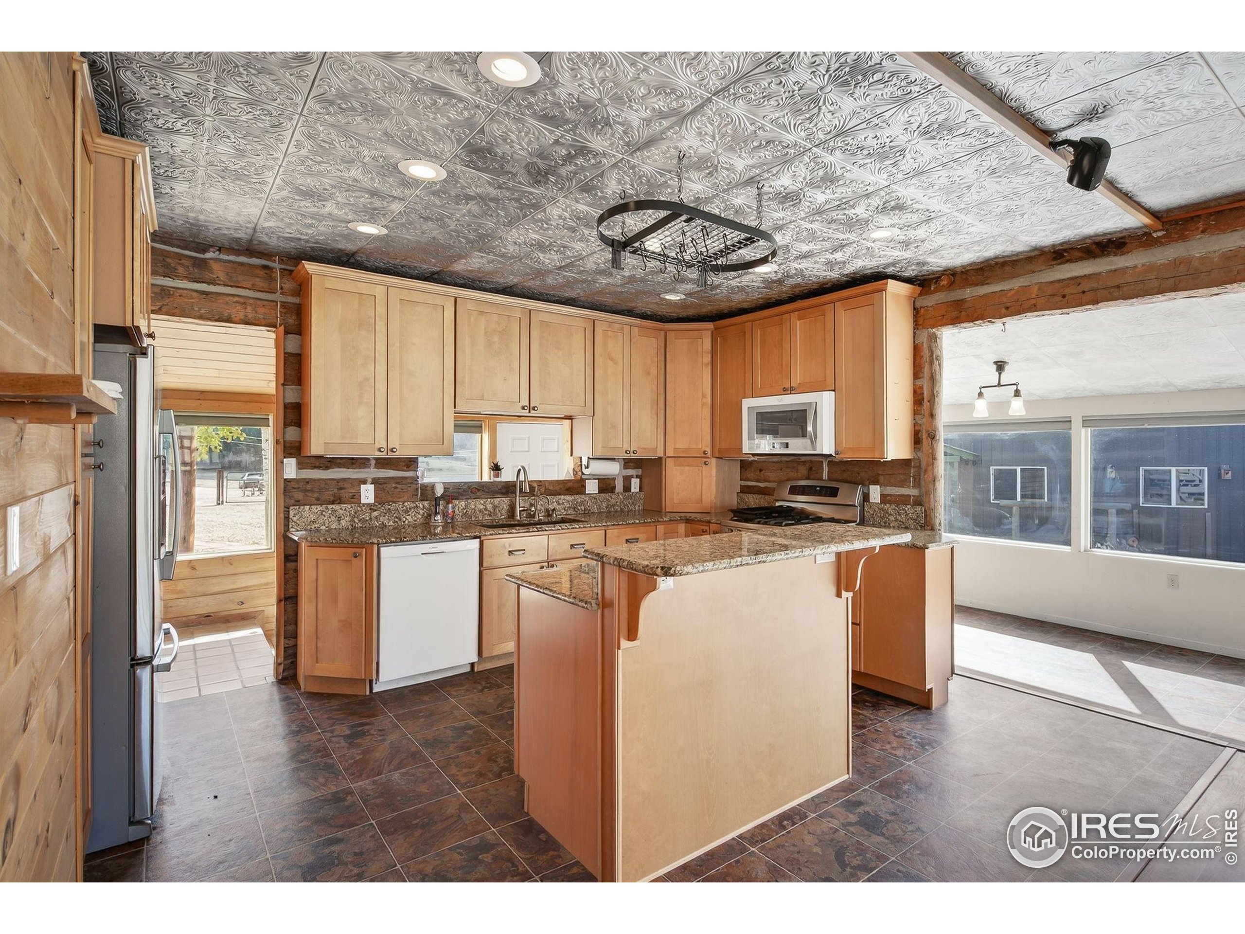 2848 Slater Creek Road Guffey, CO 80820 - Photo 6 of 50 a open kitchen with stainless steel appliances granite countertop a stove a sink dishwasher a refrigerator a oven with white cabinets and wooden floor