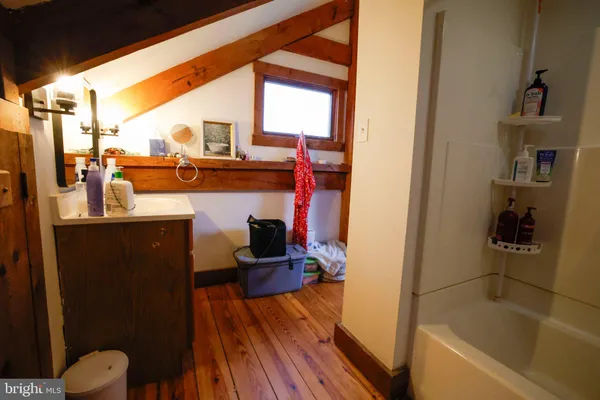 a view of a balcony with wooden floor and yard in the back