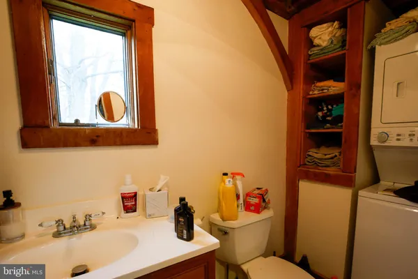 a bathroom with a sink mirror toilet and vanity