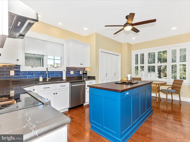a kitchen with granite countertop a sink appliances and cabinets