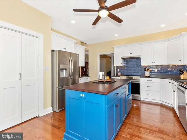 a kitchen with stainless steel appliances a sink and a refrigerator