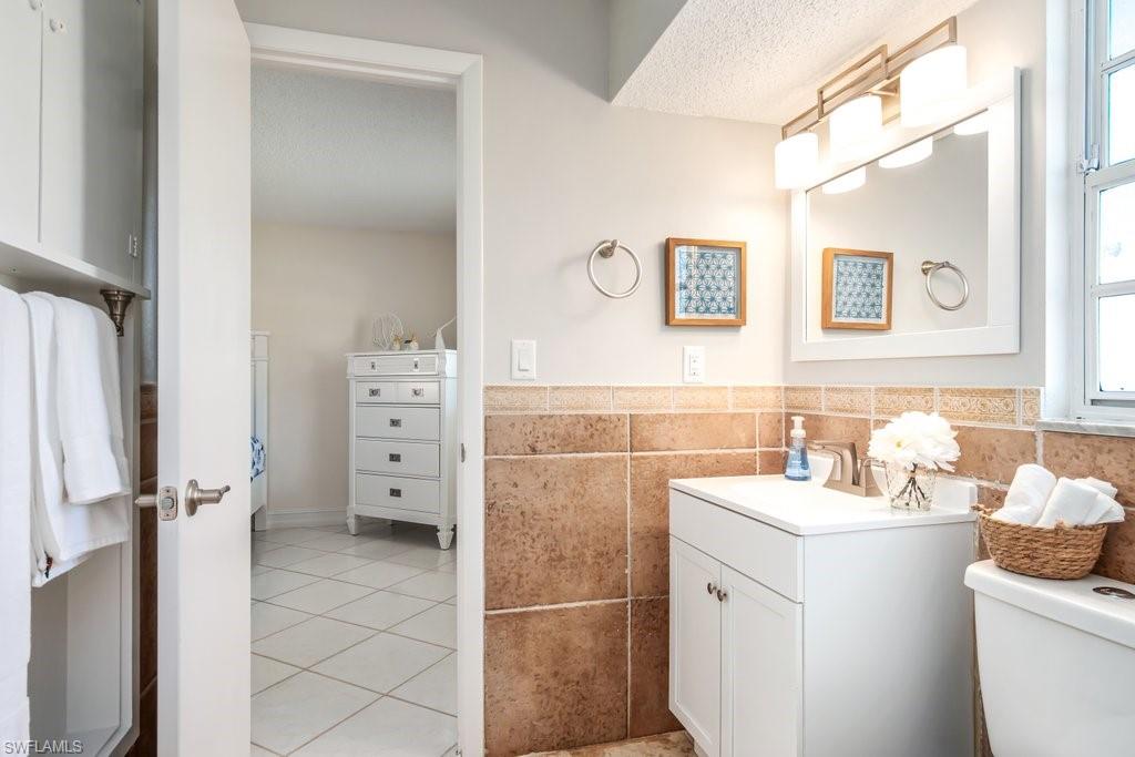 1207 Hernando Street Naples, FL 34103 - Photo 21 of 37 a bathroom with a sink toilet and shower