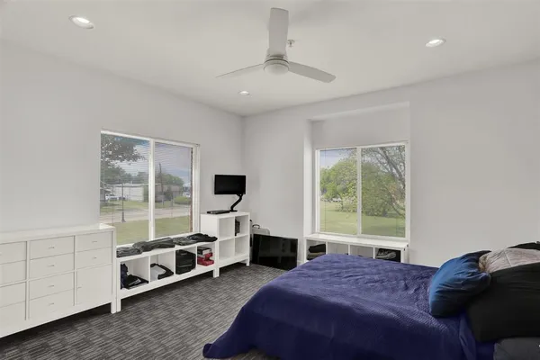 a bedroom with furniture and flat screen tv
