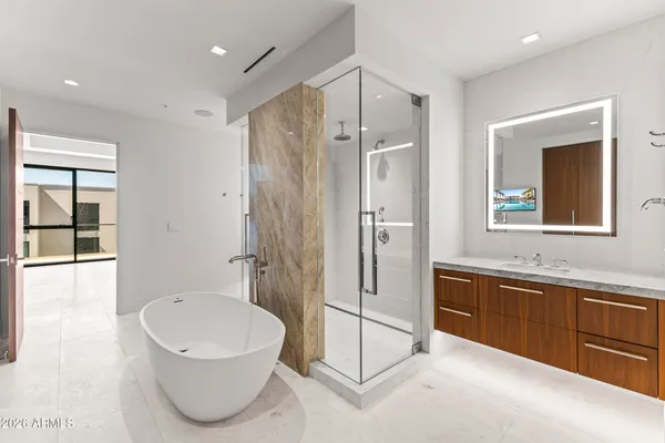 a view of a big room with windows and chandelier fan