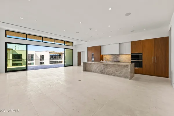 a large kitchen with kitchen island a sink stainless steel appliances and a refrigerator