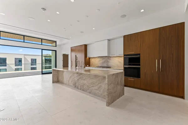 a view of an empty room with a kitchen