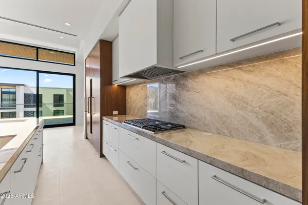 a kitchen with stainless steel appliances a cabinets and a stove top oven