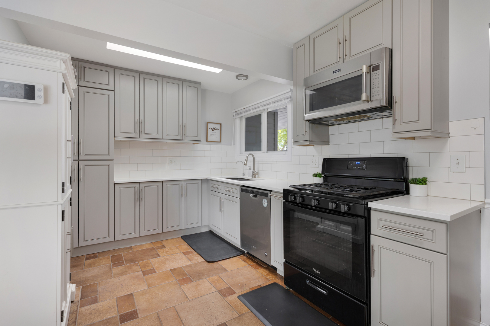 1850 Pierce Road Hoffman Estates, IL 60169 - Photo 12 of 25 a kitchen with stainless steel appliances granite countertop a stove top oven a sink dishwasher and a refrigerator with wooden cabinets