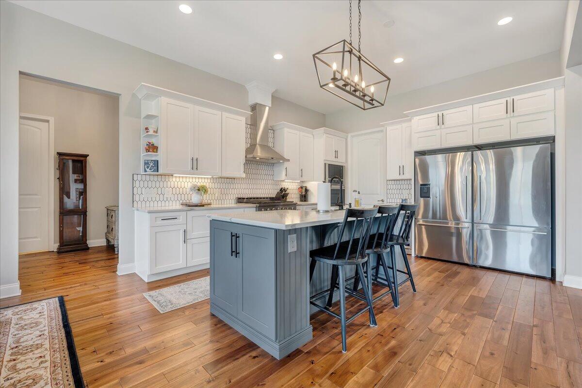 198 Thornblade Way Blue Ridge, VA 24064 - Photo 11 of 78 a kitchen with stainless steel appliances a dining table chairs and wooden floor