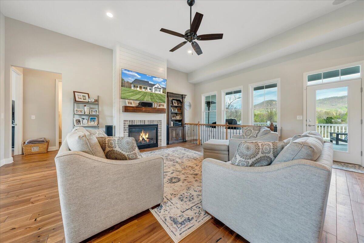 198 Thornblade Way Blue Ridge, VA 24064 - Photo 3 of 78 a living room with furniture a fireplace and a flat screen tv