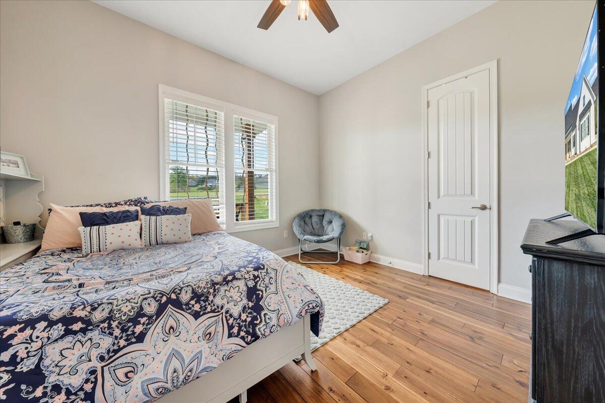 198 Thornblade Way Blue Ridge, VA 24064 - Photo 30 of 78 a bedroom with a bed and a dresser with wooden floor