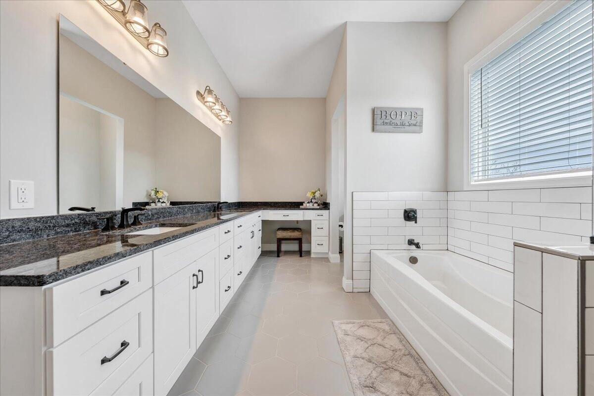 198 Thornblade Way Blue Ridge, VA 24064 - Photo 38 of 78 a large white bathroom with a granite countertop double vanity sink a bathtub and mirror
