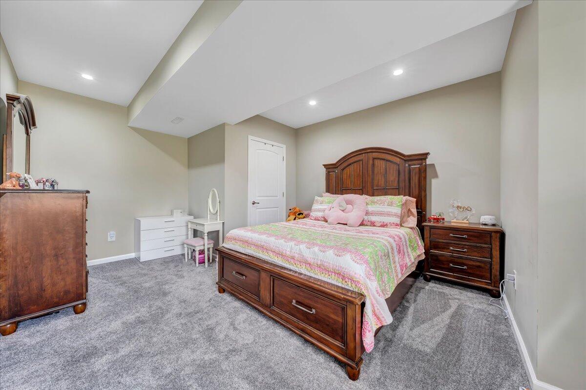 198 Thornblade Way Blue Ridge, VA 24064 - Photo 44 of 78 a spacious bedroom with a bed and a dresser in it