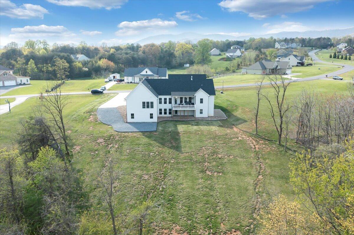 198 Thornblade Way Blue Ridge, VA 24064 - Photo 67 of 78 a view of a lake with a yard