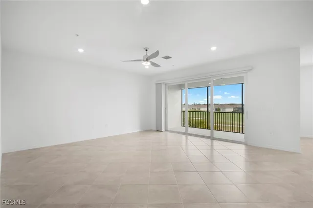 an empty room with closet and chandelier fan
