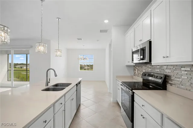 a kitchen with granite countertop a sink and cabinets
