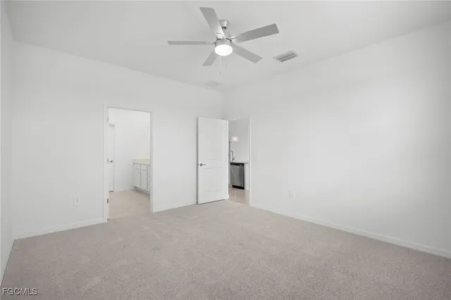 an empty room with a ceiling fan and a ceiling fan
