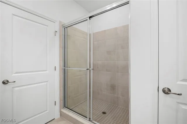 a bathroom with a glass shower door