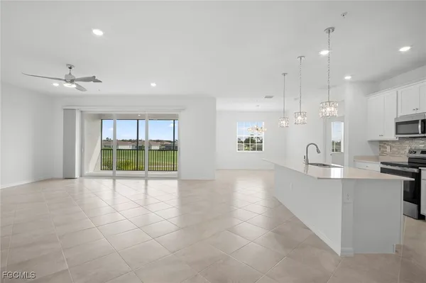a view of a kitchen with a sink and microwave