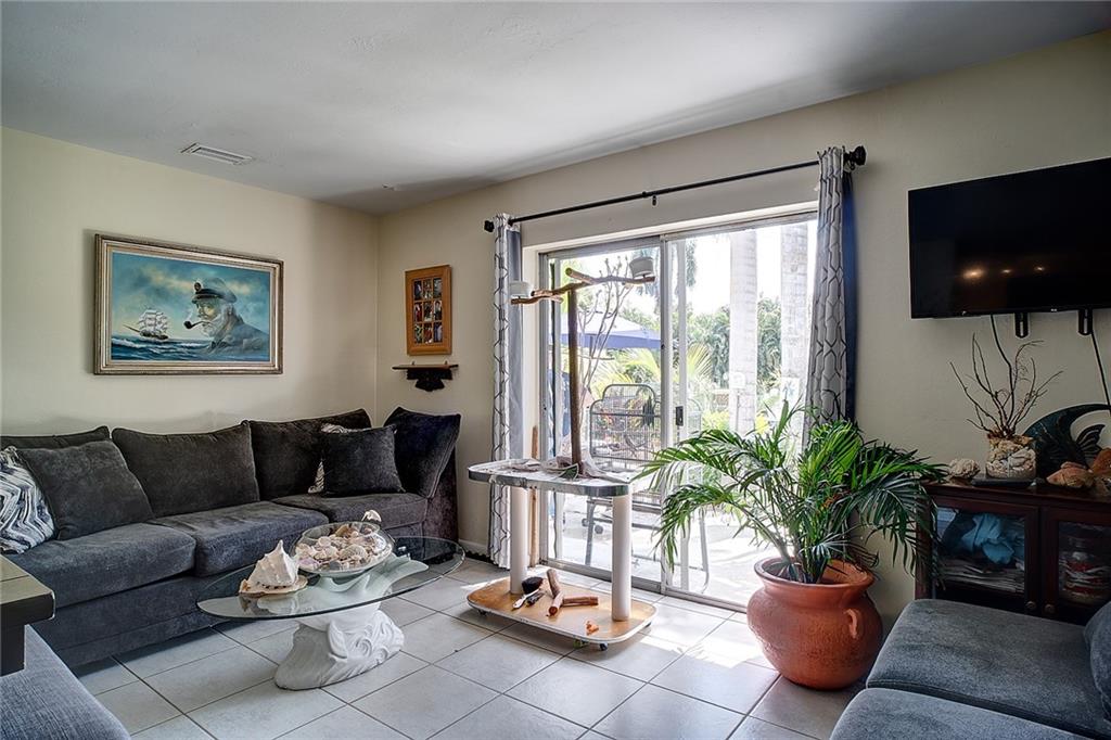 3860 Northeast 23rd Avenue Lighthouse Point, FL 33064 - Photo 14 of 33 a living room with furniture potted plant and a flat screen tv