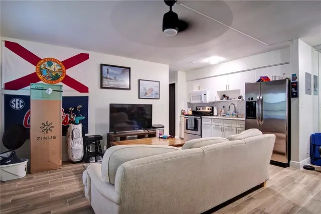 a kitchen with stainless steel appliances kitchen island granite countertop a refrigerator stove and sink