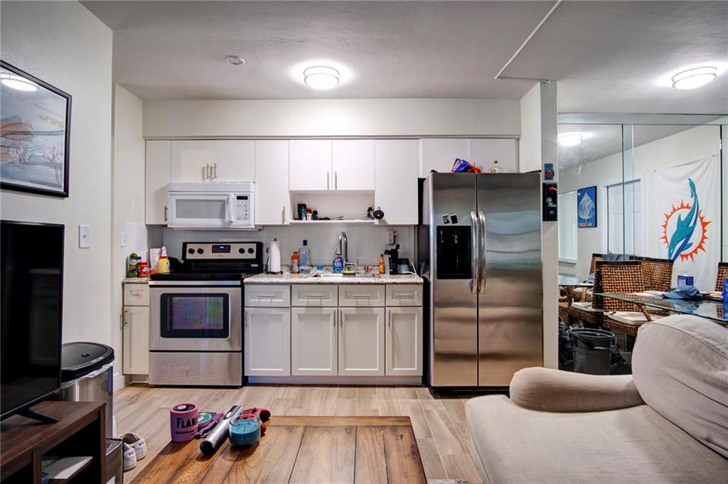 3860 Northeast 23rd Avenue Lighthouse Point, FL 33064 - Photo 26 of 33 a kitchen with stainless steel appliances kitchen island granite countertop a refrigerator stove and sink