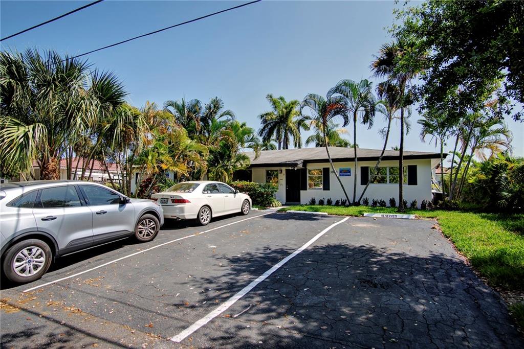 3860 Northeast 23rd Avenue Lighthouse Point, FL 33064 - Photo 3 of 33 a view of a car parked in front of a house