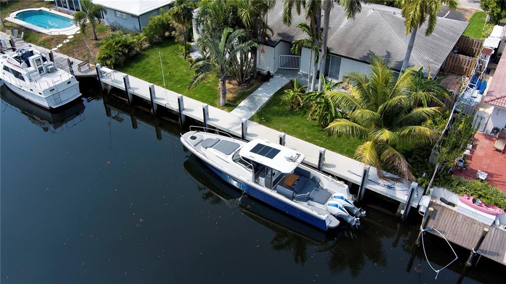 3860 Northeast 23rd Avenue Lighthouse Point, FL 33064 - Photo 4 of 33 a balcony with chairs and table