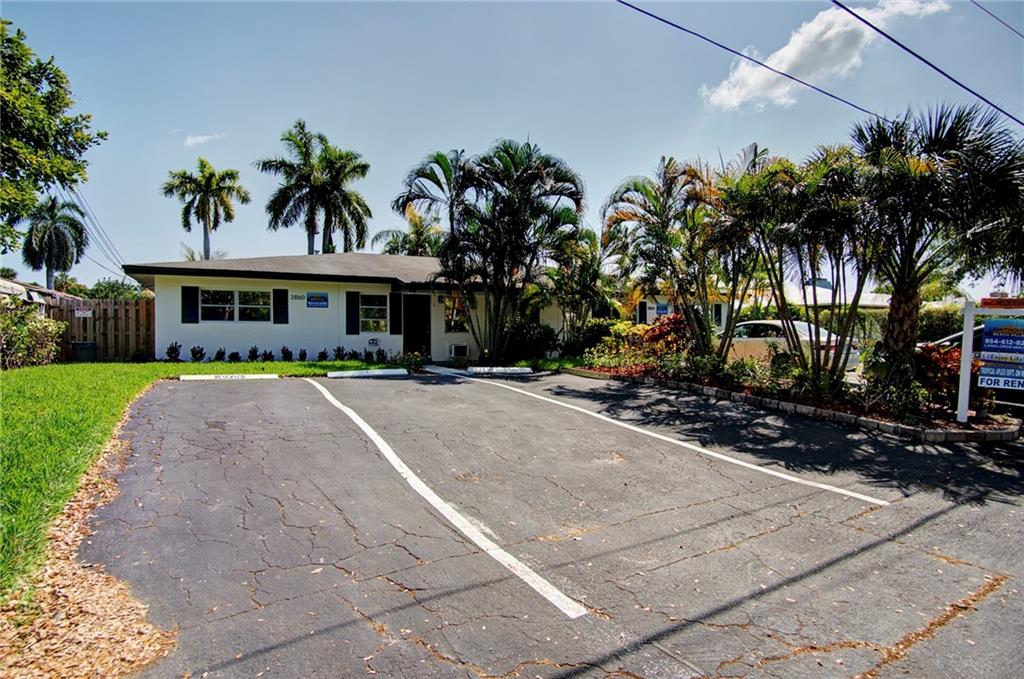 3860 Northeast 23rd Avenue Lighthouse Point, FL 33064 - Photo 8 of 33 a front view of multiple houses with yard