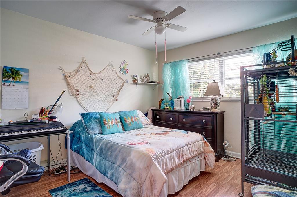 3860 Northeast 23rd Avenue Lighthouse Point, FL 33064 - Photo 10 of 33 a bedroom with a bed and wooden floor