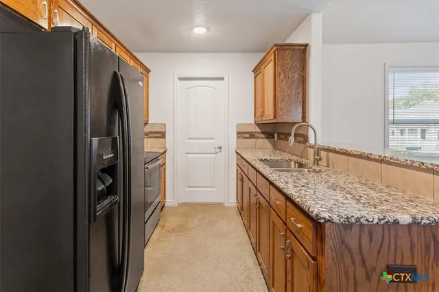 a bathroom with a granite countertop sink a mirror and shower