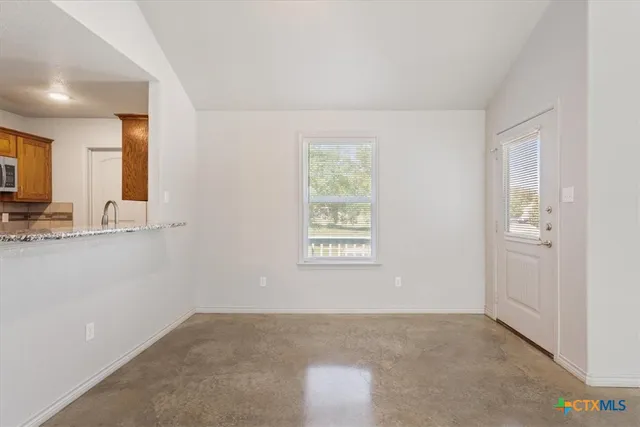 a view of an empty room with a window