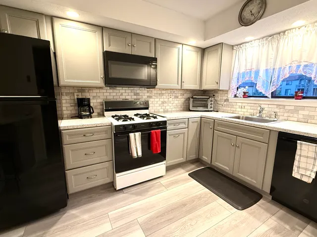 a kitchen with a stove sink and refrigerator