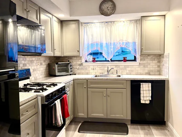 a kitchen with stainless steel appliances a stove sink and cabinets