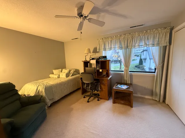 a bedroom with furniture and a window