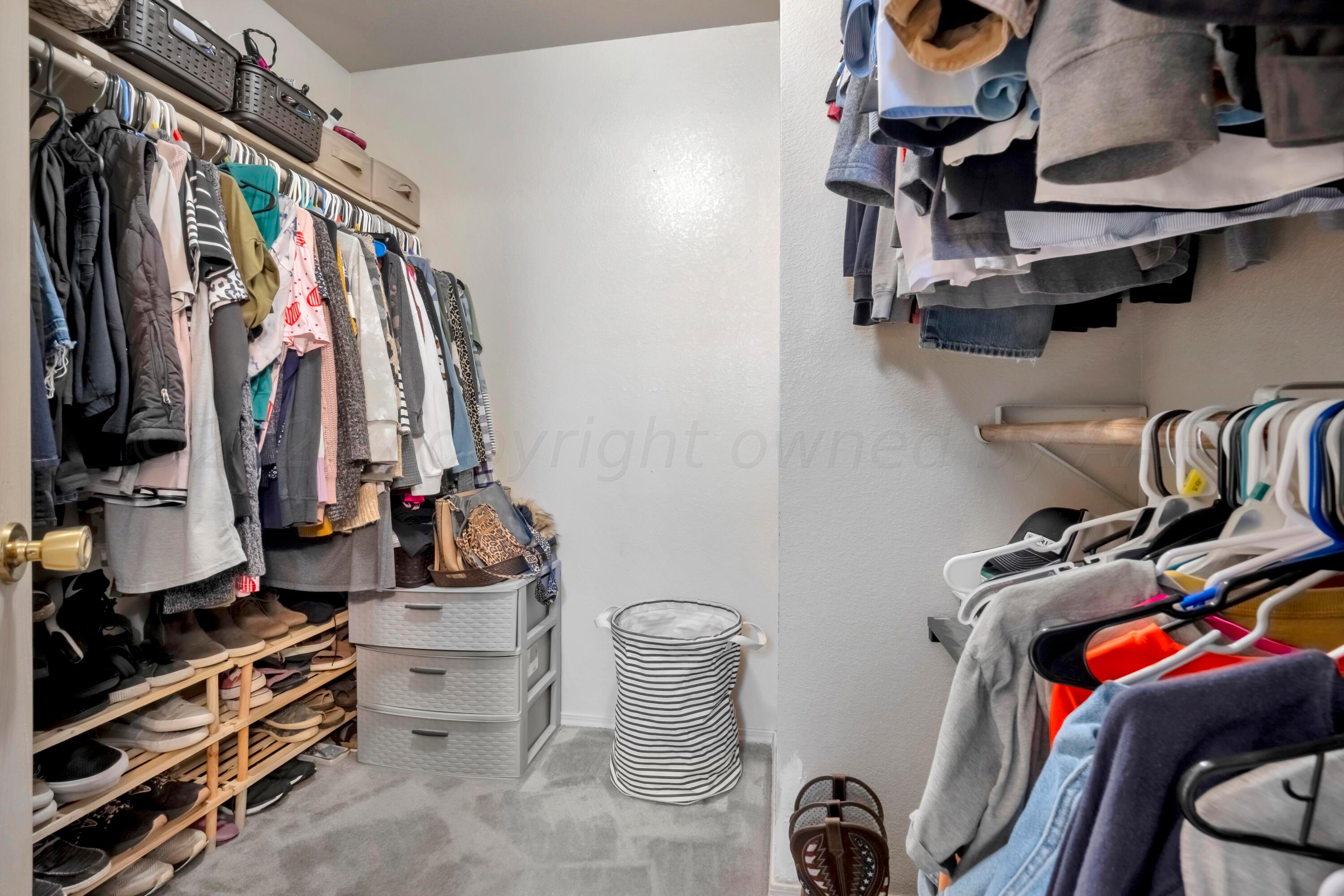 4902 Capulin Lane Amarillo, TX 79110 - Photo 15 of 25 a view of walk in closet with clothes and shoes