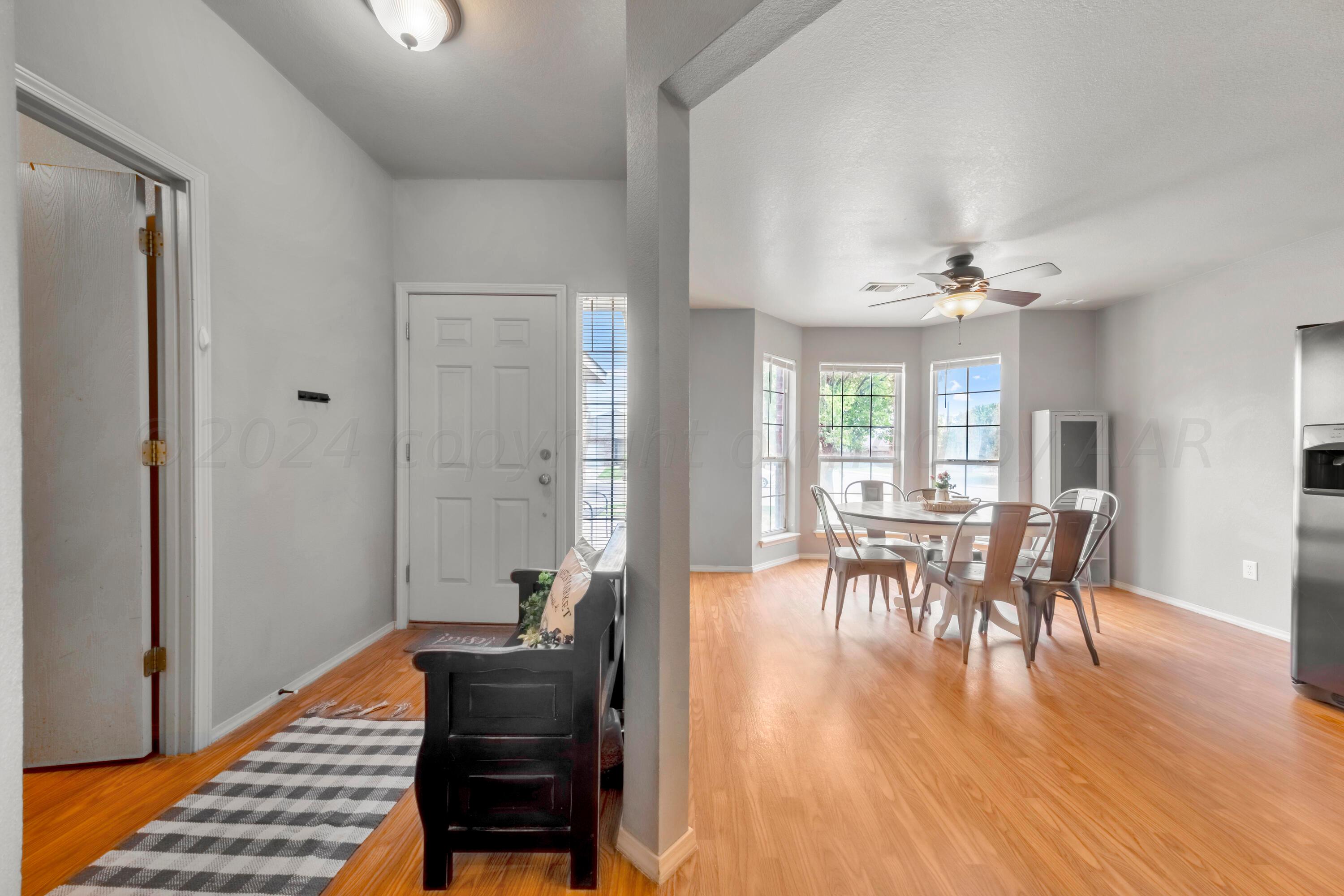 4902 Capulin Lane Amarillo, TX 79110 - Photo 4 of 25 a dining room with furniture and wooden floor