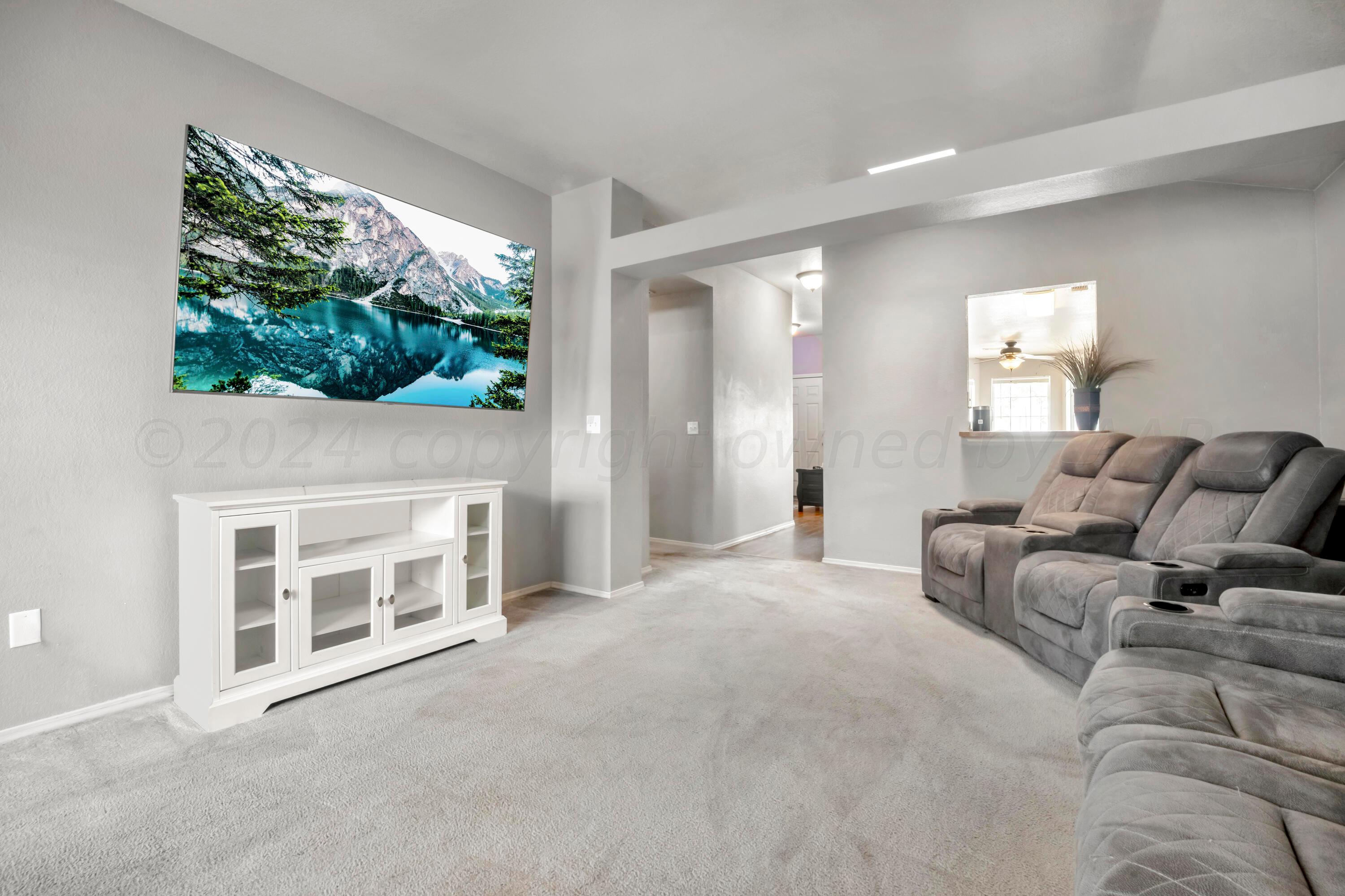 4902 Capulin Lane Amarillo, TX 79110 - Photo 8 of 25 a living room with furniture a fireplace and a large window