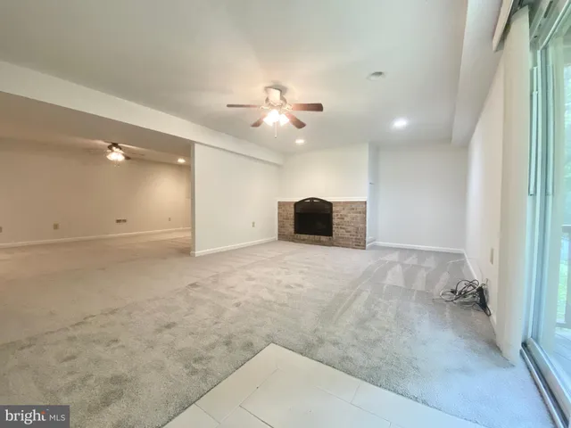wooden floor in an empty room with a ceiling fan