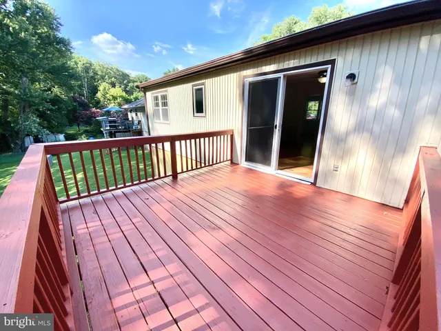 a view of backyard with deck and wooden floor