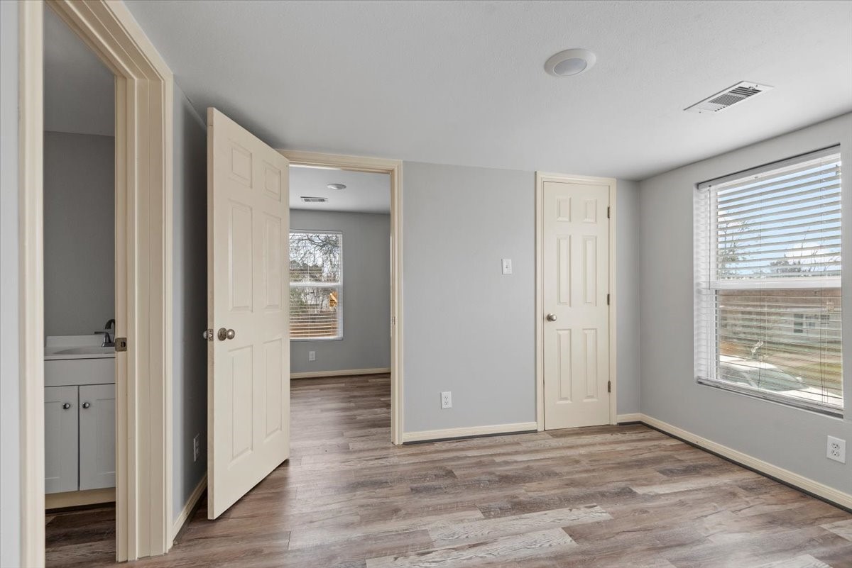 7413 Dallas Street Houston, TX 77011 - Photo 16 of 26 a view of an empty room with wooden floor and a window