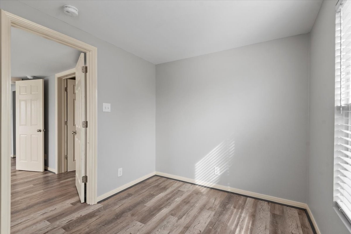7413 Dallas Street Houston, TX 77011 - Photo 21 of 26 an empty room with wooden floor and windows