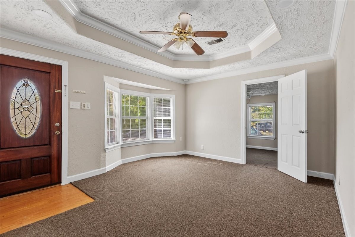 7413 Dallas Street Houston, TX 77011 - Photo 4 of 26 an empty room with windows and fan