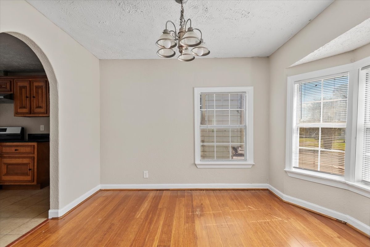 7413 Dallas Street Houston, TX 77011 - Photo 6 of 26 a view of an empty room with a window and wooden floor